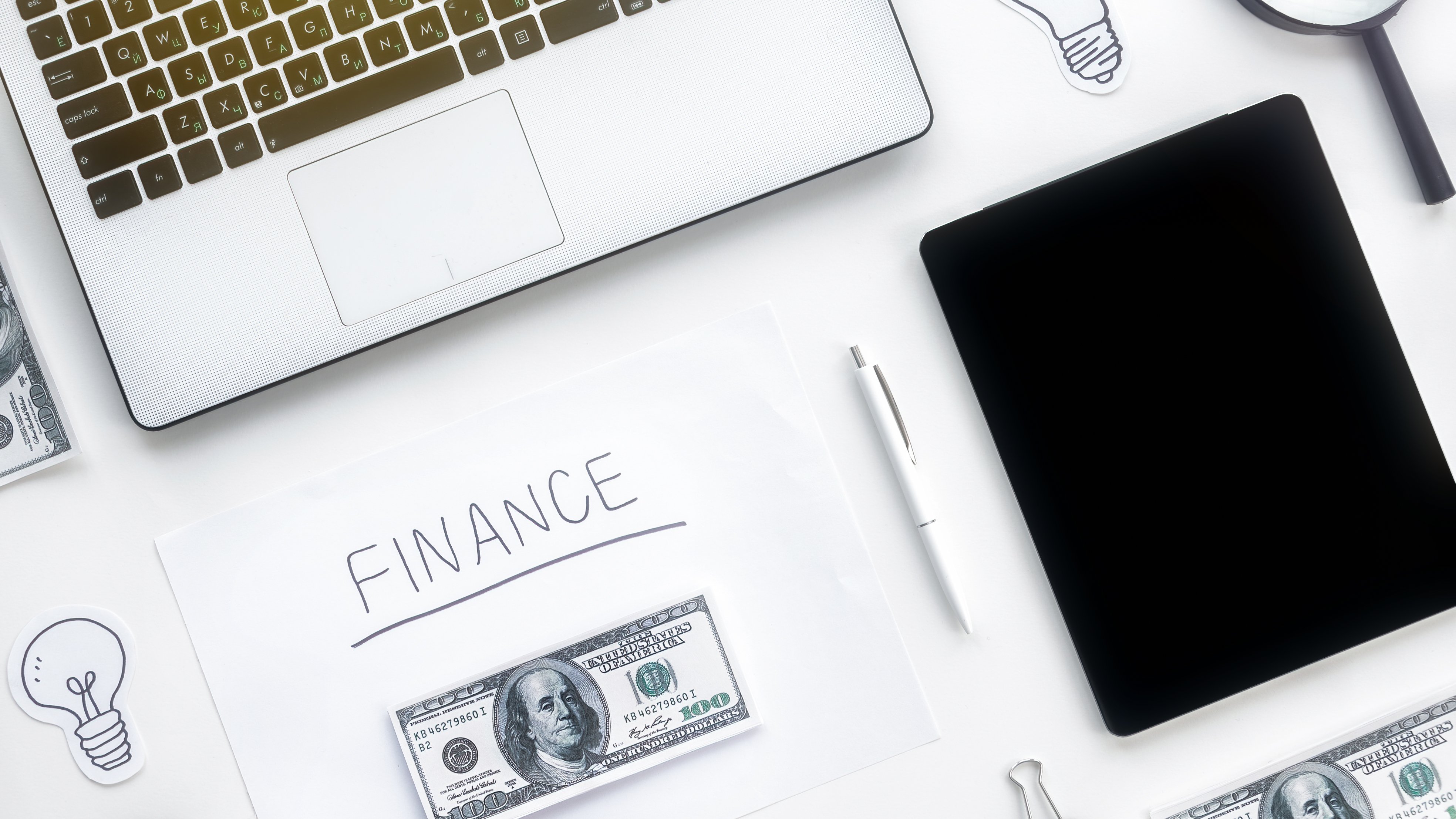 table-with-finance-work-stuff-laptop-money-tablet-pen-papers